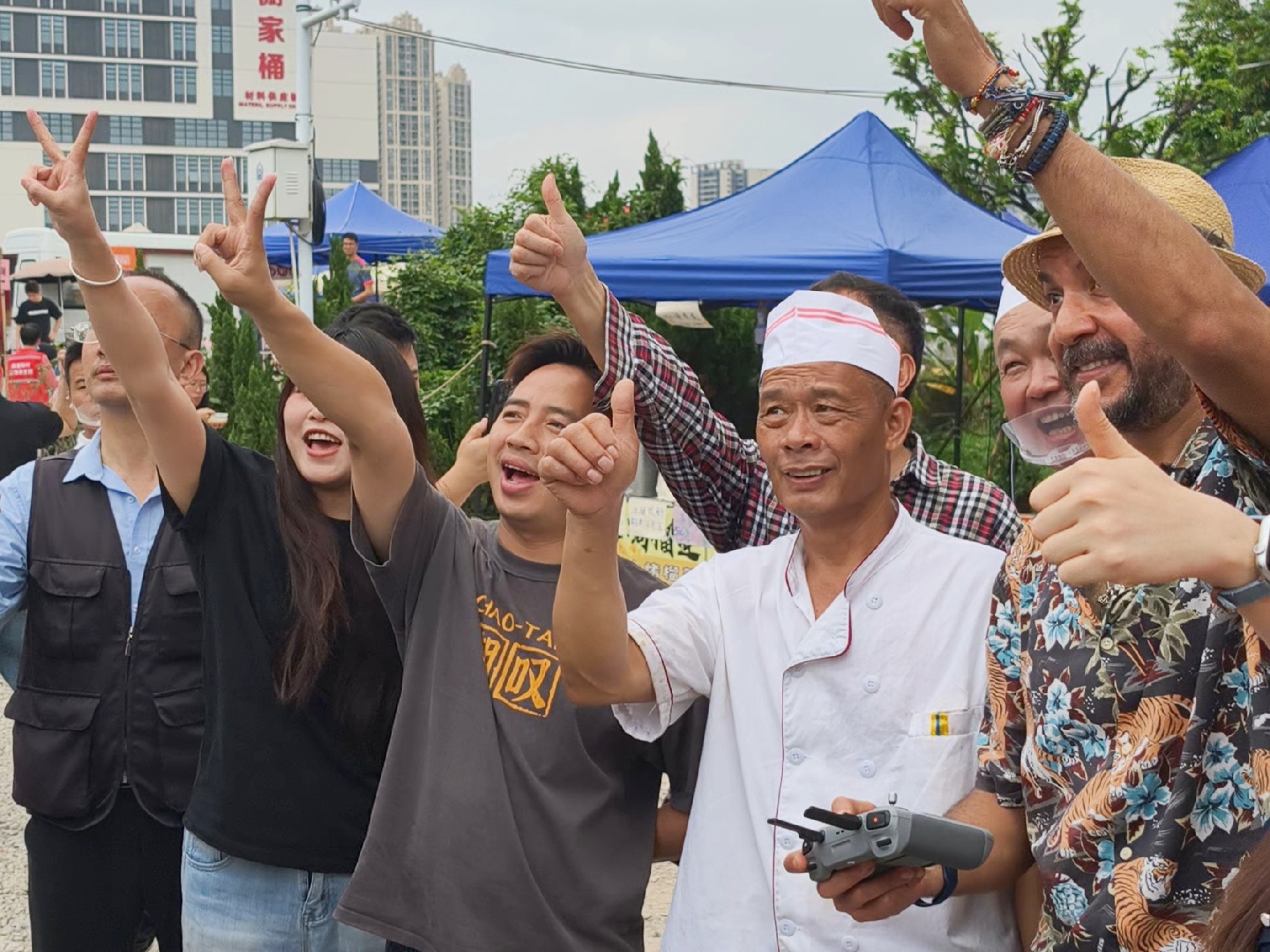 图为莫氏鸡煲小院，莫叔（右三）与海内外游客合影留念。人民网记者 王雅蝶摄